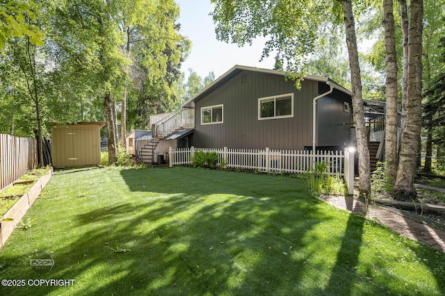13311 Cove Cir, Anchorage, AK 99515 - fenced backyard with stairs and a storage unit