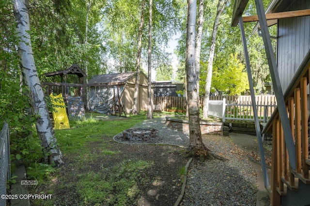 13311 Cove Cir, Anchorage, AK 99515 - view of yard with a shed and a fire pit