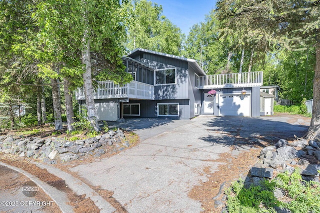13311 Cove Cir, Anchorage, AK 99515 - view of front of property with asphalt driveway, a garage, and a deck