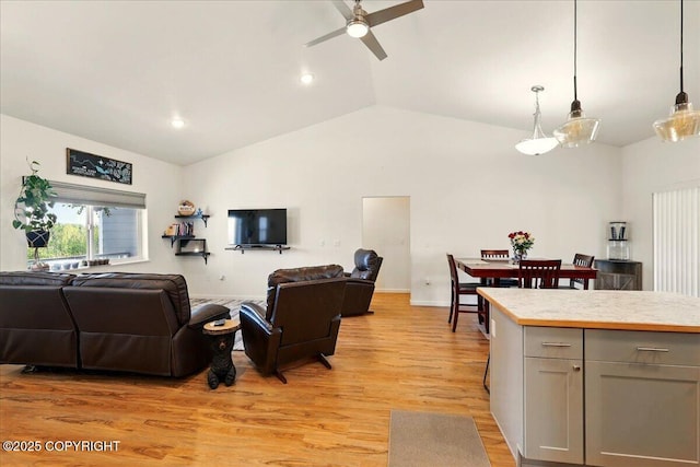 47974 Barney Ct, Soldotna, AK 99669 - living area with a ceiling fan, vaulted ceiling, light wood-style flooring, recessed lighting, and baseboards
