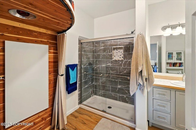 47974 Barney Ct, Soldotna, AK 99669 - bathroom featuring a stall shower, vanity, and wood finished floors