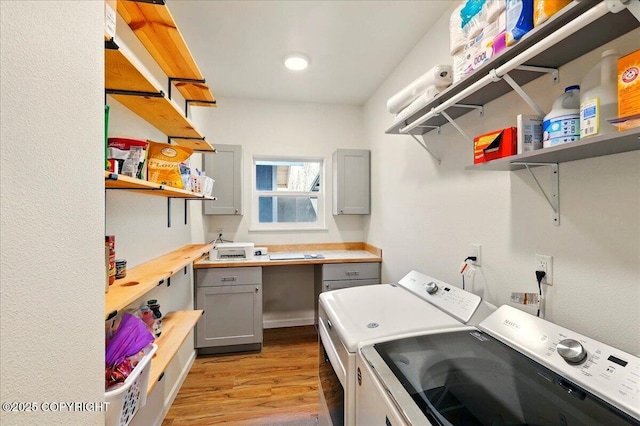 47974 Barney Ct, Soldotna, AK 99669 - washroom featuring washing machine and clothes dryer, light wood finished floors, and cabinet space