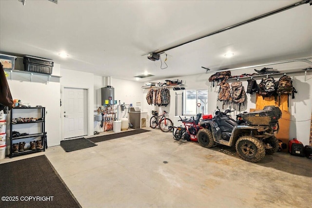 47974 Barney Ct, Soldotna, AK 99669 - garage with water heater and a garage door opener
