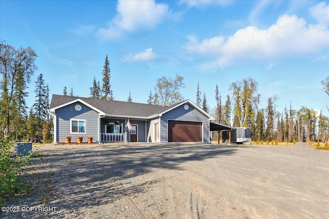 47974 Barney Ct, Soldotna, AK 99669 - ranch-style home featuring covered porch, dirt driveway, an attached garage, and a carport