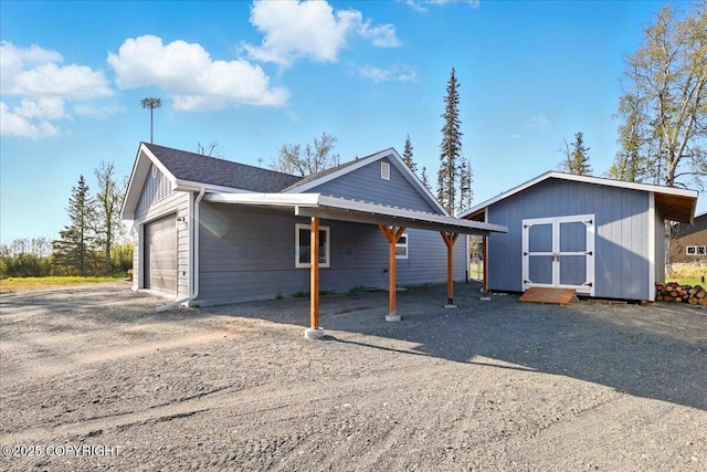 47974 Barney Ct, Soldotna, AK 99669 - view of property exterior with an attached garage and dirt driveway