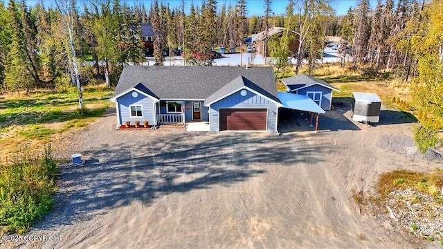 47974 Barney Ct, Soldotna, AK 99669 - single story home with dirt driveway, an attached garage, and covered porch