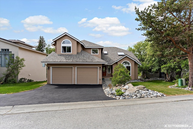 18704 Snowy Plover Cir, Anchorage, AK 99516 - traditional-style house with roof with shingles, driveway, a garage, and a front yard