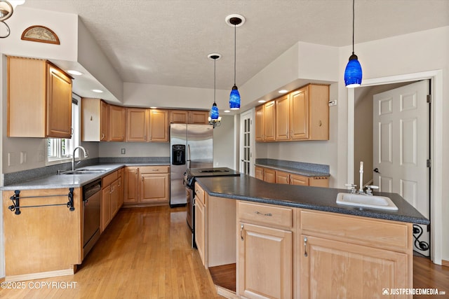 18704 Snowy Plover Cir, Anchorage, AK 99516 - kitchen featuring a sink, appliances with stainless steel finishes, a center island, light brown cabinets, and a textured ceiling