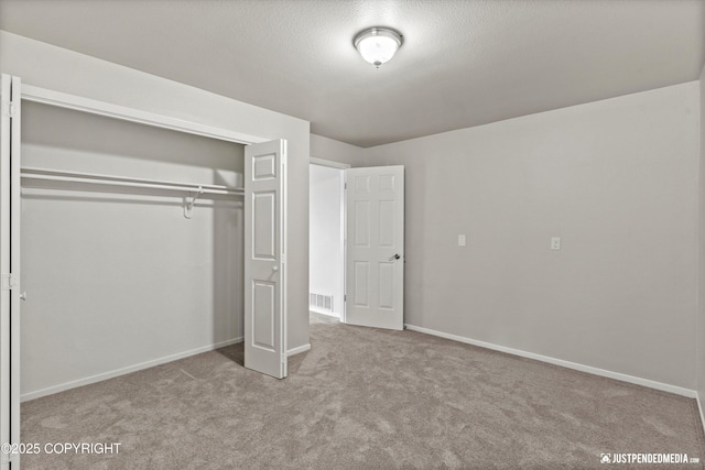 18704 Snowy Plover Cir, Anchorage, AK 99516 - unfurnished bedroom featuring carpet floors, a closet, and baseboards