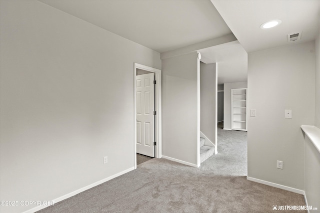 18704 Snowy Plover Cir, Anchorage, AK 99516 - unfurnished room with carpet, baseboards, and stairs