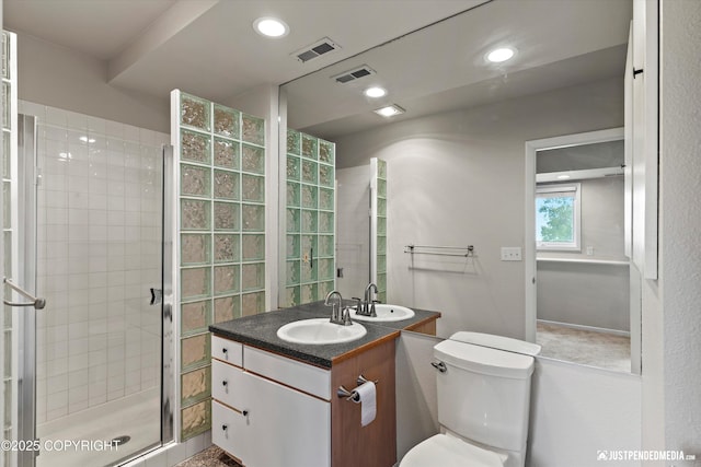 18704 Snowy Plover Cir, Anchorage, AK 99516 - full bathroom with vanity, toilet, a shower stall, and recessed lighting