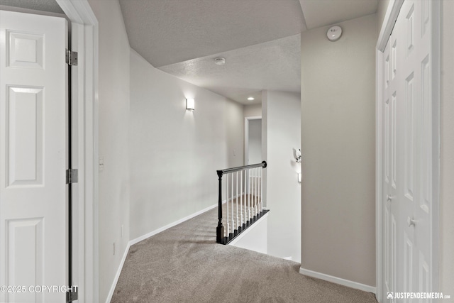 18704 Snowy Plover Cir, Anchorage, AK 99516 - hall featuring an upstairs landing, carpet floors, baseboards, and a textured ceiling