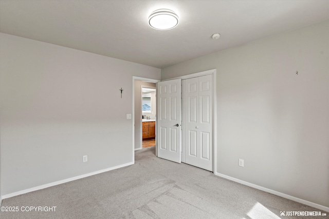 18704 Snowy Plover Cir, Anchorage, AK 99516 - unfurnished bedroom with light colored carpet, baseboards, and a closet