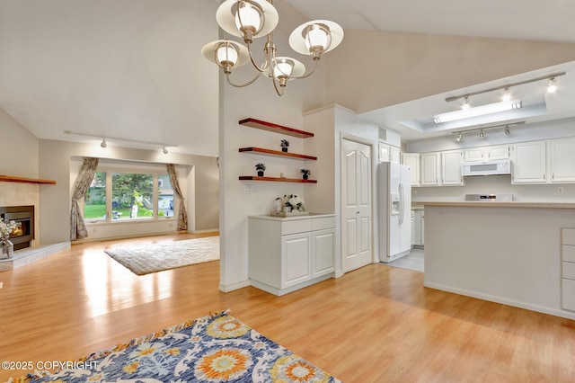 13521 Ebbtide Cir, Anchorage, AK 99516 - kitchen featuring track lighting, white appliances, light wood-type flooring, light countertops, and high vaulted ceiling
