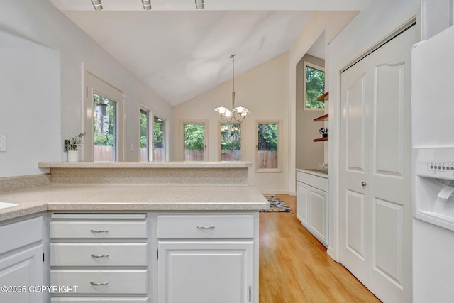 13521 Ebbtide Cir, Anchorage, AK 99516 - kitchen with plenty of natural light, light wood-style flooring, light countertops, a chandelier, and lofted ceiling