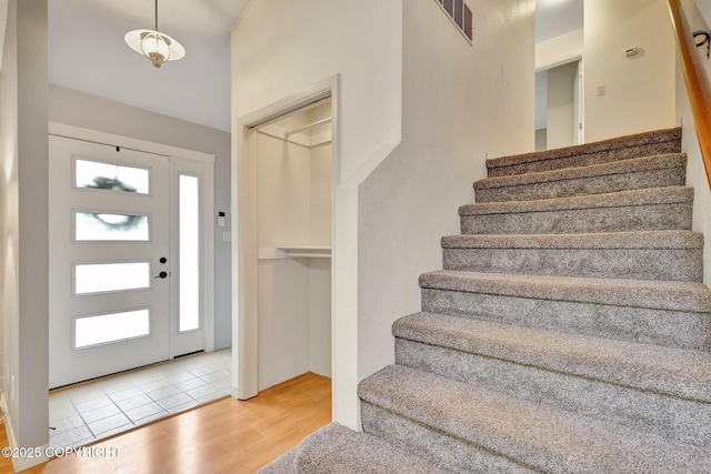 13521 Ebbtide Cir, Anchorage, AK 99516 - entrance foyer featuring stairway and wood finished floors