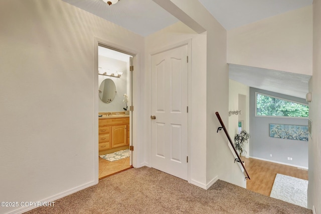 13521 Ebbtide Cir, Anchorage, AK 99516 - corridor featuring an upstairs landing, carpet flooring, baseboards, and a sink