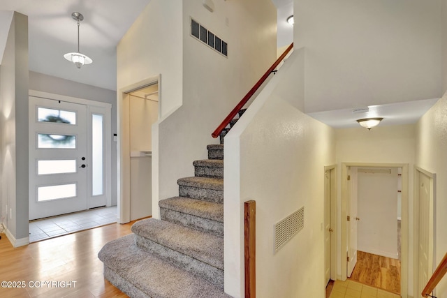 13521 Ebbtide Cir, Anchorage, AK 99516 - entrance foyer featuring wood finished floors, stairs, and a high ceiling