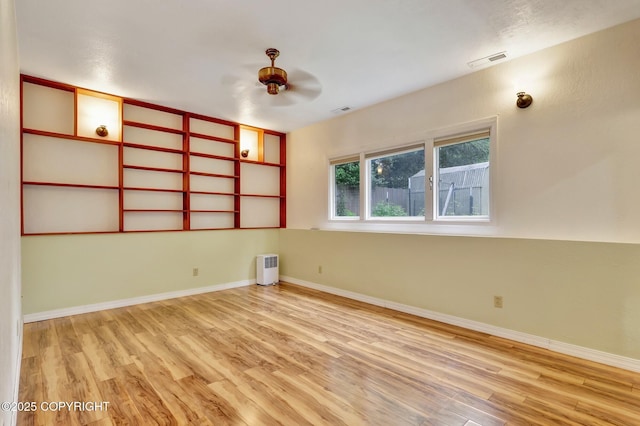 13521 Ebbtide Cir, Anchorage, AK 99516 - empty room with wood finished floors, a ceiling fan, and baseboards