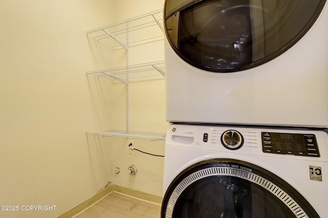 13521 Ebbtide Cir, Anchorage, AK 99516 - laundry room featuring stacked washing machine and dryer and baseboards