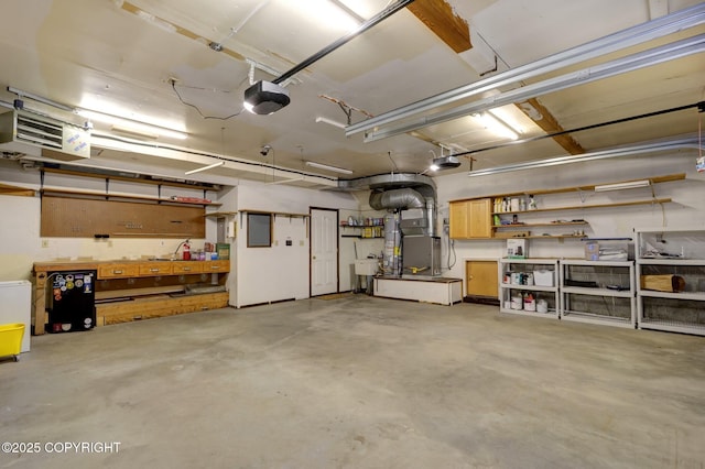 13521 Ebbtide Cir, Anchorage, AK 99516 - garage with a workshop area, a heating unit, heating unit, a garage door opener, and a sink