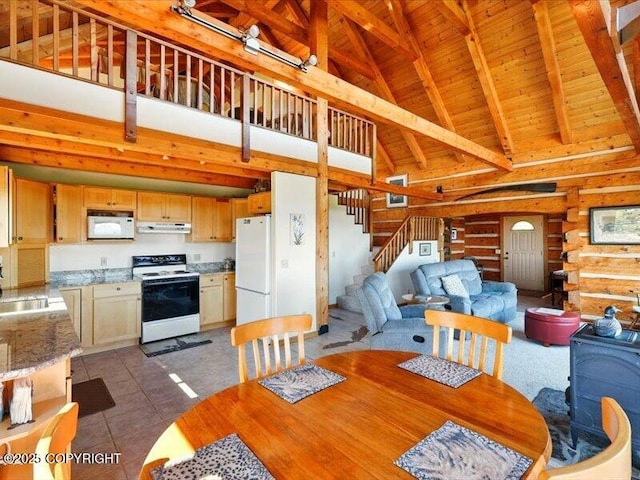 58820 E End Rd, Homer, AK 99603 - dining area with high vaulted ceiling, wood ceiling with exposed beams, stairs, and light tile patterned flooring