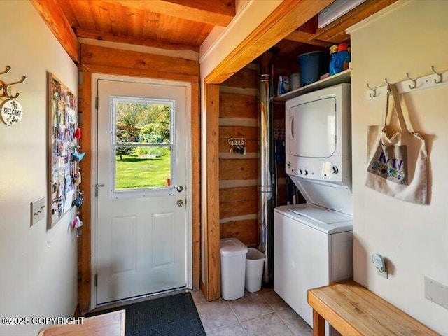 58820 E End Rd, Homer, AK 99603 - laundry area with stacked washing machine and dryer, wood ceiling, and light tile patterned flooring