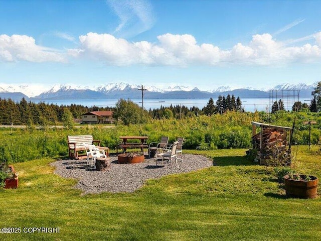 58820 E End Rd, Homer, AK 99603 - view of green lawn featuring a fire pit and a water and mountain view