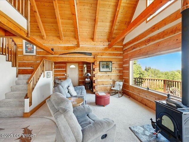 58820 E End Rd, Homer, AK 99603 - carpeted living room with wood ceiling, log walls, a wood stove, and stairs