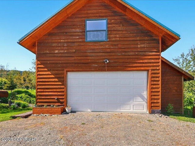 58820 E End Rd, Homer, AK 99603 - view of side of property featuring dirt driveway, a garage, and an outdoor structure