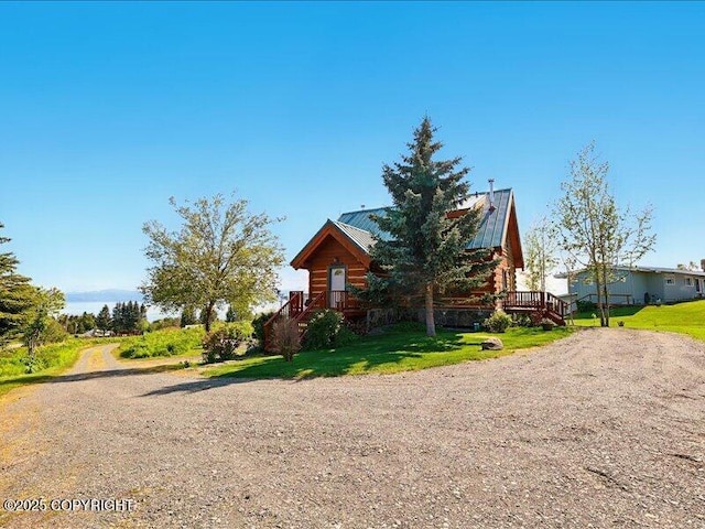58820 E End Rd, Homer, AK 99603 - view of side of home featuring driveway, a yard, and metal roof