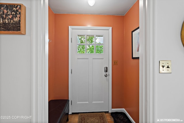 1310 G St, Anchorage, AK 99501 - doorway to outside with dark wood-style flooring and baseboards