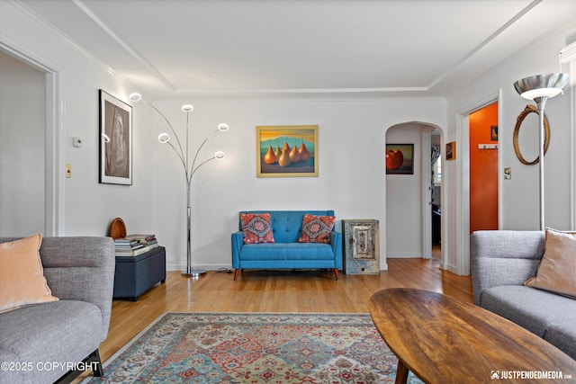 1310 G St, Anchorage, AK 99501 - living area featuring arched walkways, wood finished floors, baseboards, and crown molding