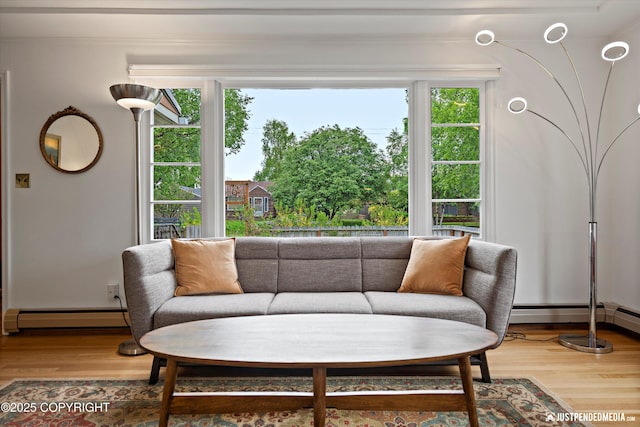 1310 G St, Anchorage, AK 99501 - sitting room featuring a baseboard heating unit, wood finished floors, and baseboards
