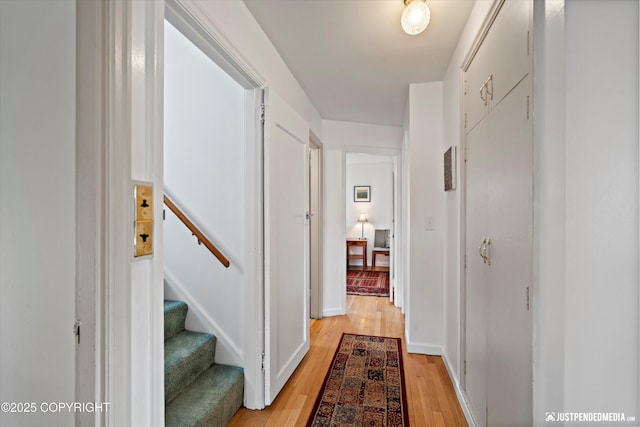1310 G St, Anchorage, AK 99501 - hallway with light wood-type flooring, baseboards, and stairway