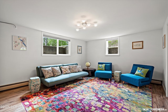 1310 G St, Anchorage, AK 99501 - living area featuring wood finished floors, a baseboard radiator, and healthy amount of natural light