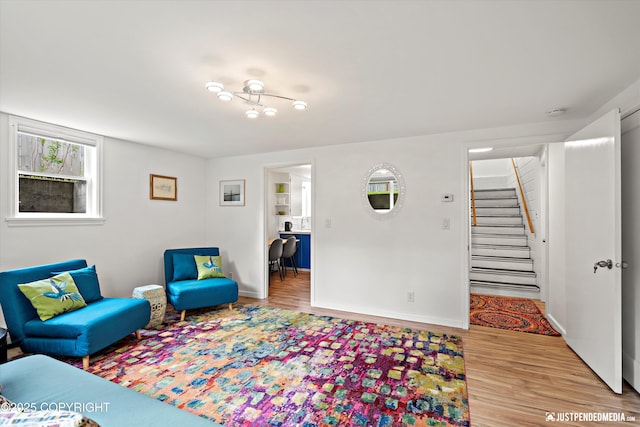 1310 G St, Anchorage, AK 99501 - living room featuring wood finished floors, stairway, and baseboards