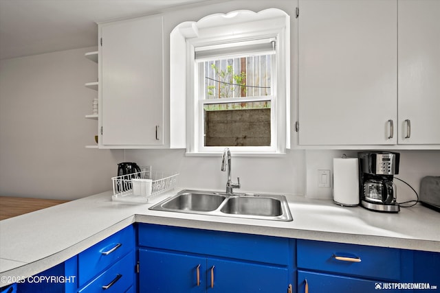 1310 G St, Anchorage, AK 99501 - kitchen with a sink, blue cabinetry, light countertops, and open shelves