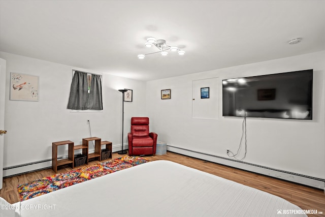1310 G St, Anchorage, AK 99501 - bedroom featuring wood finished floors and a baseboard radiator