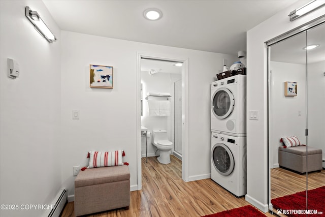 1310 G St, Anchorage, AK 99501 - laundry area with stacked washing machine and dryer, light wood finished floors, baseboards, and baseboard heating
