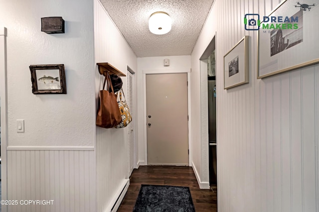 190 Grand Larry St Unit A-01, Anchorage, AK 99504 - entryway featuring dark wood-style floors, a textured ceiling, and a baseboard radiator