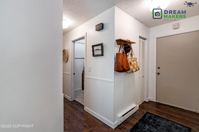 190 Grand Larry St Unit A-01, Anchorage, AK 99504 - foyer with a baseboard radiator, a textured ceiling, and wood finished floors
