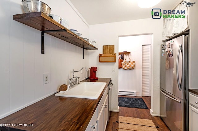 190 Grand Larry St Unit A-01, Anchorage, AK 99504 - laundry area with baseboard heating and dark wood finished floors
