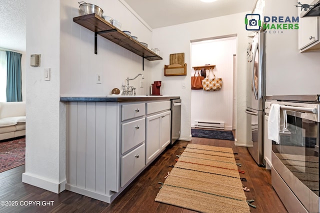 190 Grand Larry St Unit A-01, Anchorage, AK 99504 - kitchen featuring stainless steel appliances, open shelves, baseboard heating, dark wood finished floors, and ventilation hood