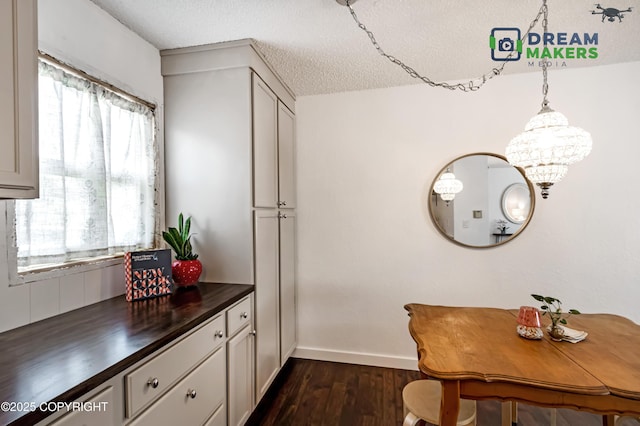 190 Grand Larry St Unit A-01, Anchorage, AK 99504 - dining area featuring dark wood finished floors, a textured ceiling, and a chandelier
