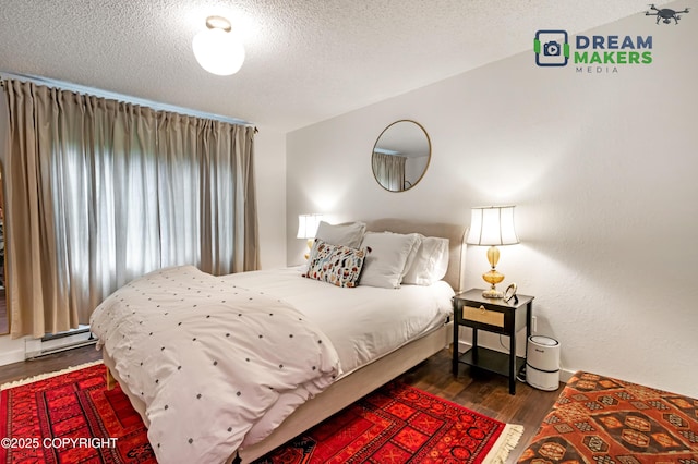 190 Grand Larry St Unit A-01, Anchorage, AK 99504 - bedroom with wood finished floors, a textured ceiling, and baseboard heating