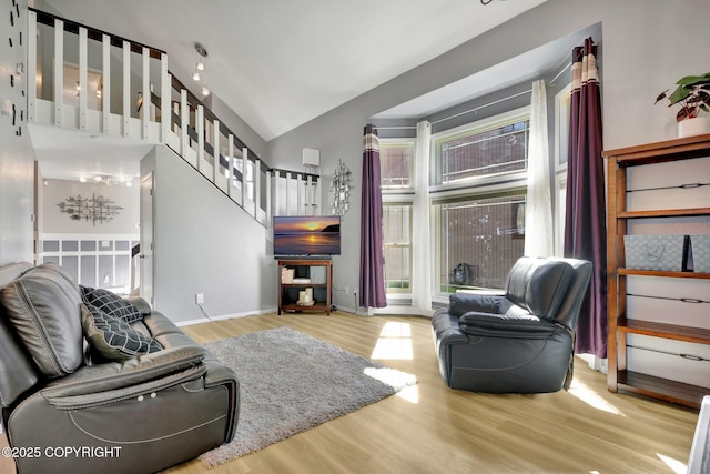 3370 Chaparral Cir, Anchorage, AK 99502 - living area featuring wood finished floors, healthy amount of natural light, stairs, and high vaulted ceiling