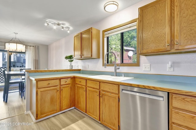 3370 Chaparral Cir, Anchorage, AK 99502 - kitchen featuring dishwasher, a sink, light wood finished floors, light countertops, and a peninsula
