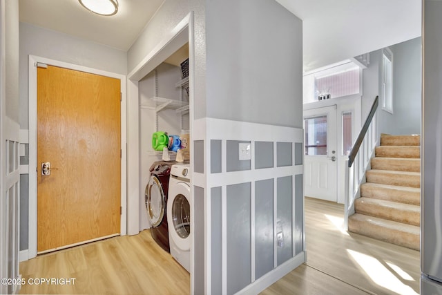 3370 Chaparral Cir, Anchorage, AK 99502 - laundry area featuring washing machine and dryer and wood finished floors