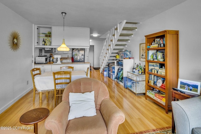 824 O Pl, Anchorage, AK 99501 - dining room with stairway, light wood-type flooring, and baseboards